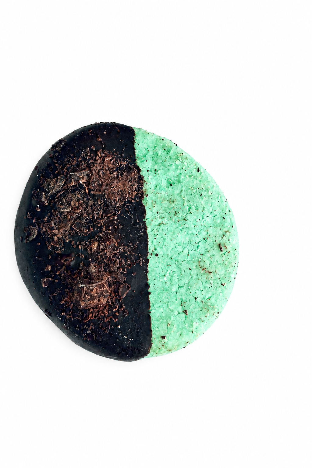 Cookie with loose chocolate pieces removed and a bright white background